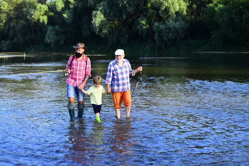 Senior man fishing with son and grandson. Man with his son and father on river fishing with fishing rods. Fishing became a popular recreational activity. Senior man fishing with son and grandson. Man with his son and father on river fishing with fishing rods. Fishing became a popular recreational activity