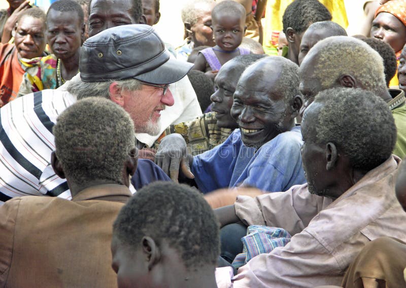 A smile is the universal language of love.  As seen in this image above of a senior caucasian Christian man breaking the language and cultural barrier by connecting with these wonderful old smiling African men which resulted in lots of shared laughter and special moments for all concerned.
We were on the ground in a remote northern village of Uganda, Africa taking aid and relief in the form of sacks of beans, cereal and other food along with bales of clothing for children and adults.

This image is for editorial purposes only. A smile is the universal language of love.  As seen in this image above of a senior caucasian Christian man breaking the language and cultural barrier by connecting with these wonderful old smiling African men which resulted in lots of shared laughter and special moments for all concerned.
We were on the ground in a remote northern village of Uganda, Africa taking aid and relief in the form of sacks of beans, cereal and other food along with bales of clothing for children and adults.

This image is for editorial purposes only.