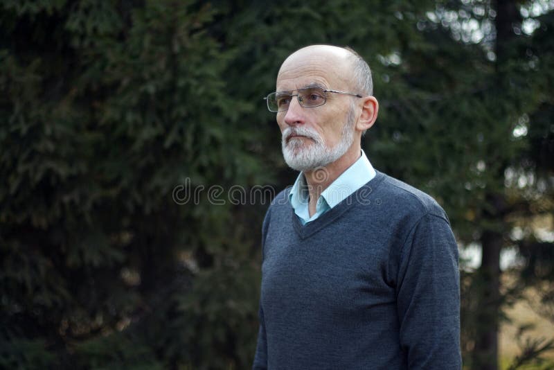 Starszy łysy mężczyzna z brodą i okularami w kurtce zdjęcie stock Starszy łysy mężczyzna z brodą i okularami w kurtce zdjęcie stock