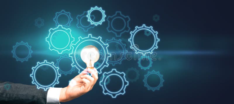 Start up and idea concept with digital gears and glowing light bulb in man hand