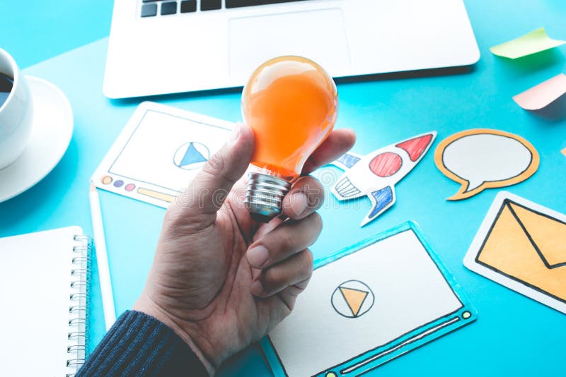 Start up idea concepts with light bulb in male hand stock photo