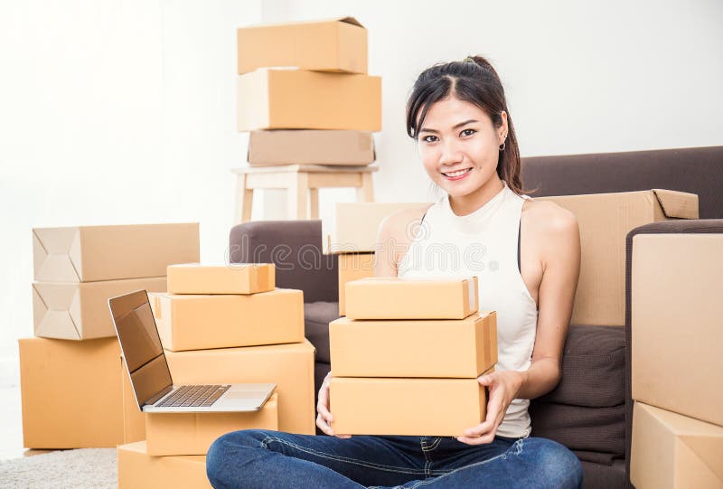 Freelance woman holding boxes working at home concept royalty free stock photo Freelance woman holding boxes working at home concept royalty free stock photo