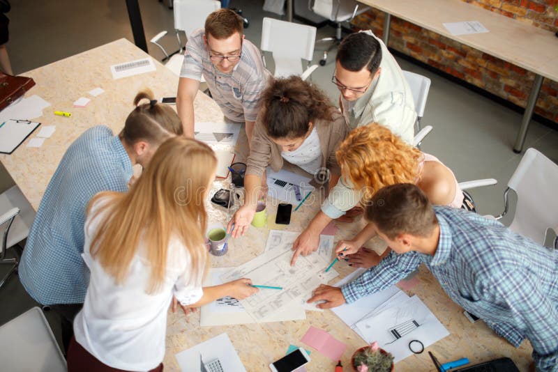 Successful concept. Students smiling and doing group work in the modern office. royalty free stock photo
