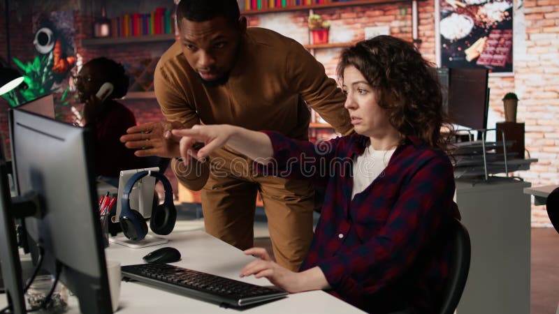Startup office supervisor checking up on IT expert using artificial intelligence stock video footage