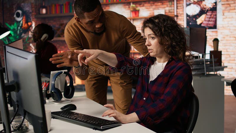 Startup office supervisor checking up on IT expert using artificial intelligence royalty free stock photo