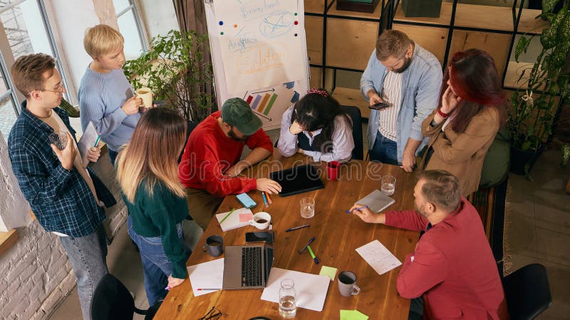 Startup team discussing ideas in open office space. stock photography