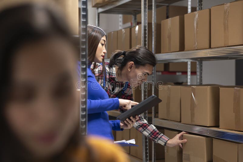 Startup warehouse staff overseeing packaging tasks for local delivery stock photography
