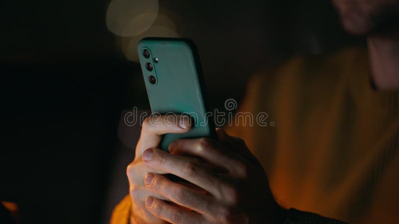 Startuper hands holding cellphone in night office closeup. Unrecognizable man stock video