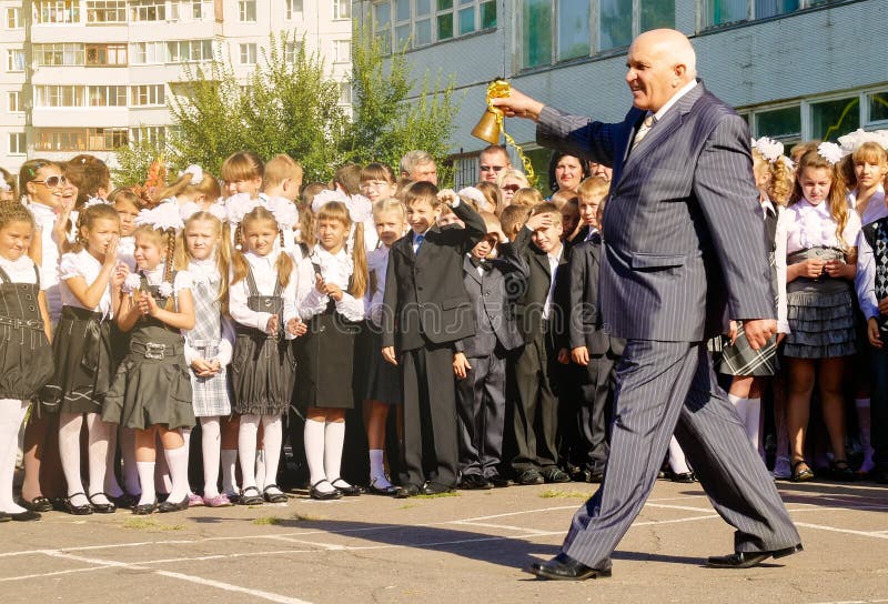 Voronezh, Russia - September 01, 2011: The old teacher opens the Russian academic year ringing the bell on the school line September 1. Voronezh, Russia - September 01, 2011: The old teacher opens the Russian academic year ringing the bell on the school line September 1.