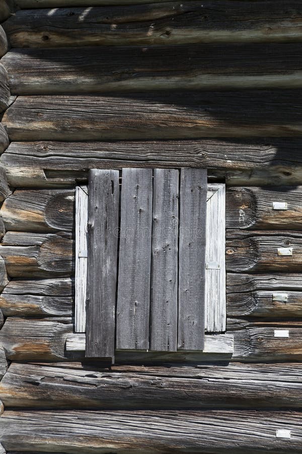 Old window hammered wooden planks of a wooden house, an abandoned farmhouse Russia. Disruption in the village, the abandoned settlements. Old window hammered wooden planks of a wooden house, an abandoned farmhouse Russia. Disruption in the village, the abandoned settlements