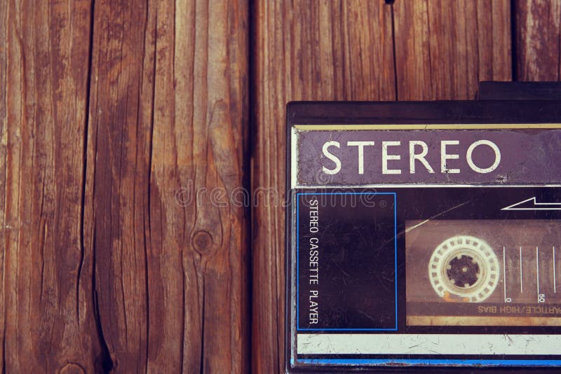 Old portable cassette player on a wooden background. image is instagram style filtered. Old portable cassette player on a wooden background. image is instagram style filtered.