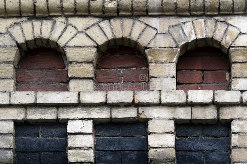 Old brick wall with three niches for background. Old brick wall with three niches for background