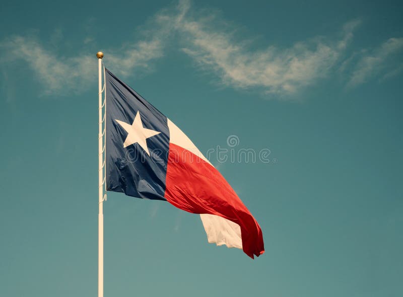 State flag of Texas against blue sky stock photography State flag of Texas against blue sky stock photography