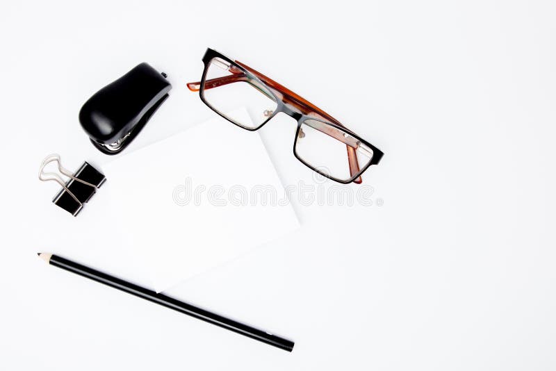 Stationary concept, Flat Lay top view Photo of pencil, stapled, paper clips, eyepieces, notes on white background with copy space royalty free stock photography Stationary concept, Flat Lay top view Photo of pencil, stapled, paper clips, eyepieces, notes on white background with copy space royalty free stock photography