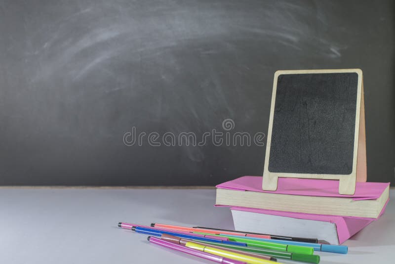 Stationery, Books, Mini Blackboard Placed on Table in Classroom Stock