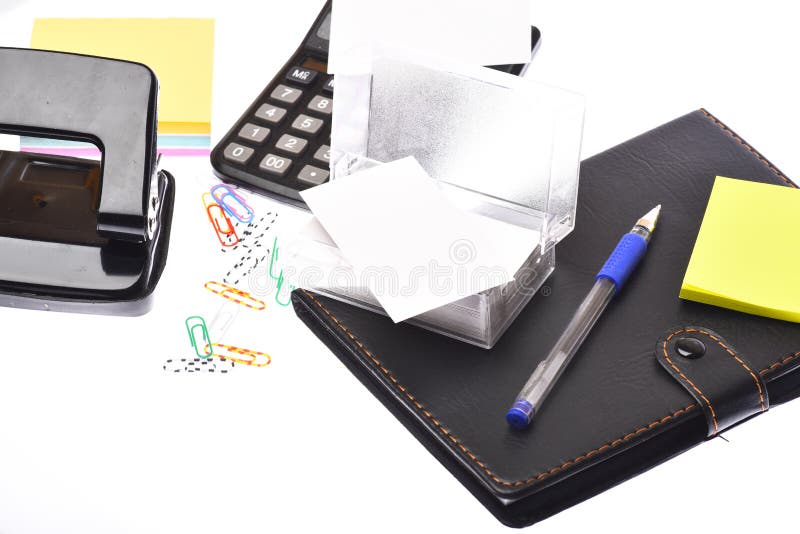 Stationery: notebook, hole punch, card holder, notes, pen and clips stock photo