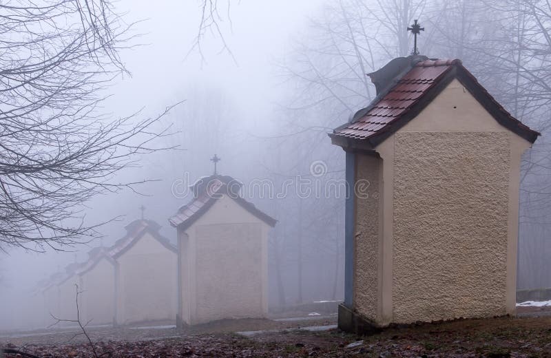 Stations of the Cross on a hill in winter fog. Clouds before sunset hiding buildings of the Stations of the Cross royalty free stock images Stations of the Cross on a hill in winter fog. Clouds before sunset hiding buildings of the Stations of the Cross royalty free stock images