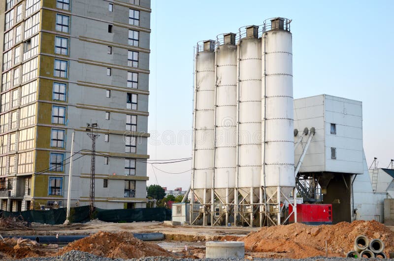 Stationary concrete batching plant on construction site. Producing сoncrete for construction and portland cement mortar. Stationary concrete batching plant on construction site. Producing сoncrete for construction and portland cement mortar