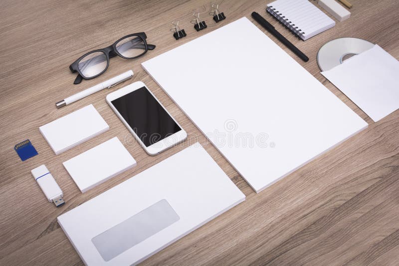 Stationary mockup on wooden background. Showing different items with no content. Stationary mockup on wooden background. Showing different items with no content.