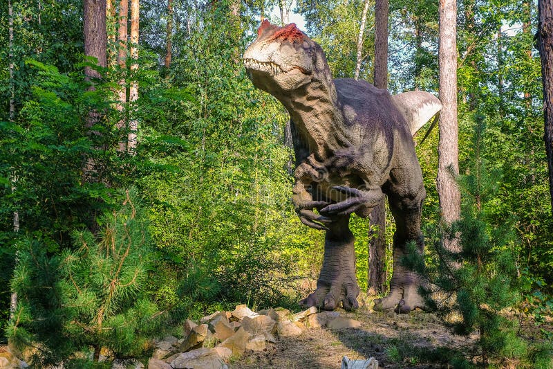 Belgorod, Russia - September 10, 2022: Full-size statue of allosaurus in dinopark of Belgorod city. Belgorod, Russia - September 10, 2022: Full-size statue of allosaurus in dinopark of Belgorod city.