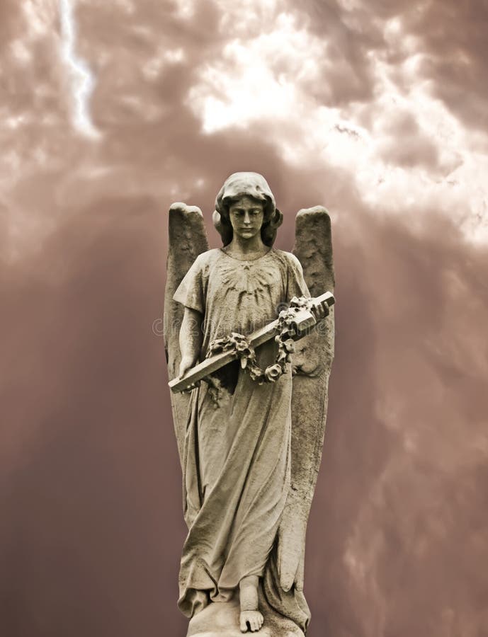 Angel holding a cross statue. Angel holding a cross statue