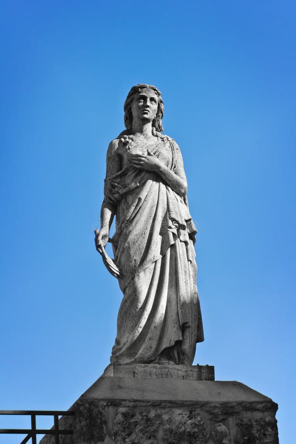 Statue of Saint Agatha on the top of Romanesque basilica of Sant'Agata in Asciano, Tuscany, Italy. Statue of Saint Agatha on the top of Romanesque basilica of Sant'Agata in Asciano, Tuscany, Italy