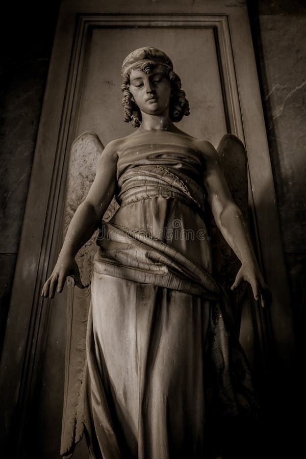 Statue of angel on an old tomb located in Genoa cemetery - Italy