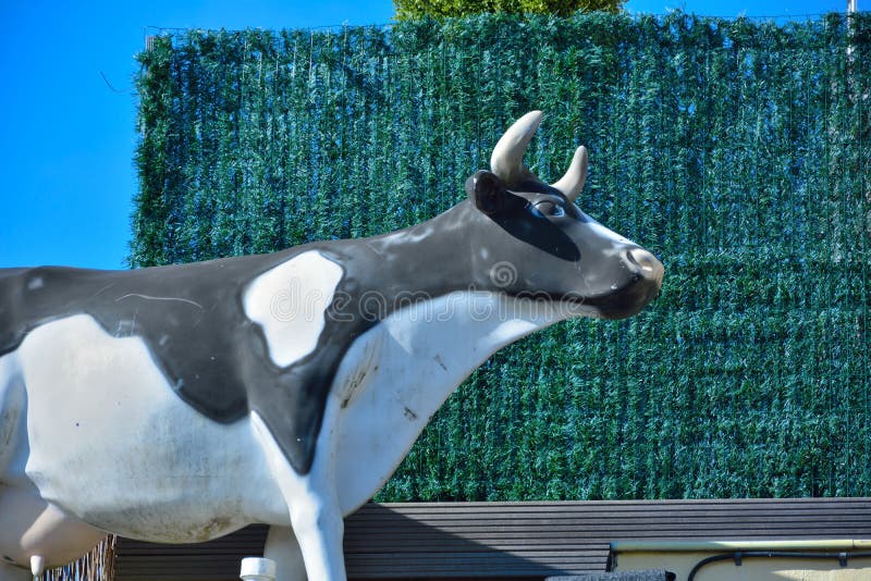 Statue of a black and white cow