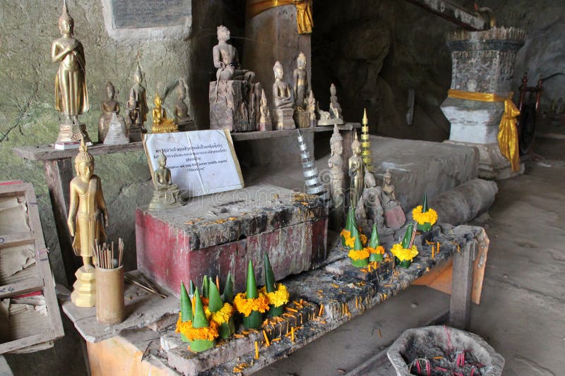 statues of buddha at the pak ou caves closed to luang prabang in laos. statues of buddha at the pak ou caves closed to luang prabang in laos