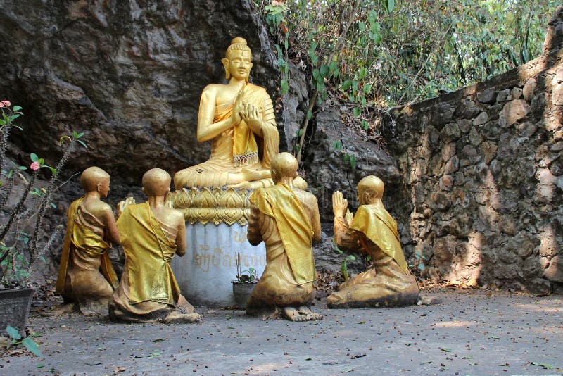 statues of monk and buddhist divinity at mount phou si in luang prabang in laos. statues of monk and buddhist divinity at mount phou si in luang prabang in laos
