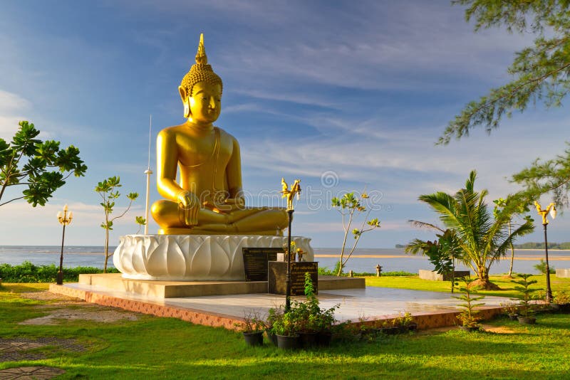 Statue of golden Buddha at the sea in Thailand