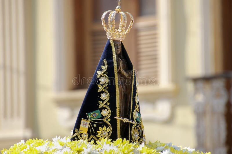 Statue of the image of Our Lady of Aparecida, mother of God in the Catholic religion, patroness of Brazil, decorated with flowers in open parade