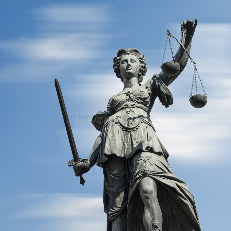 Statue of justice Justitia against blue sky