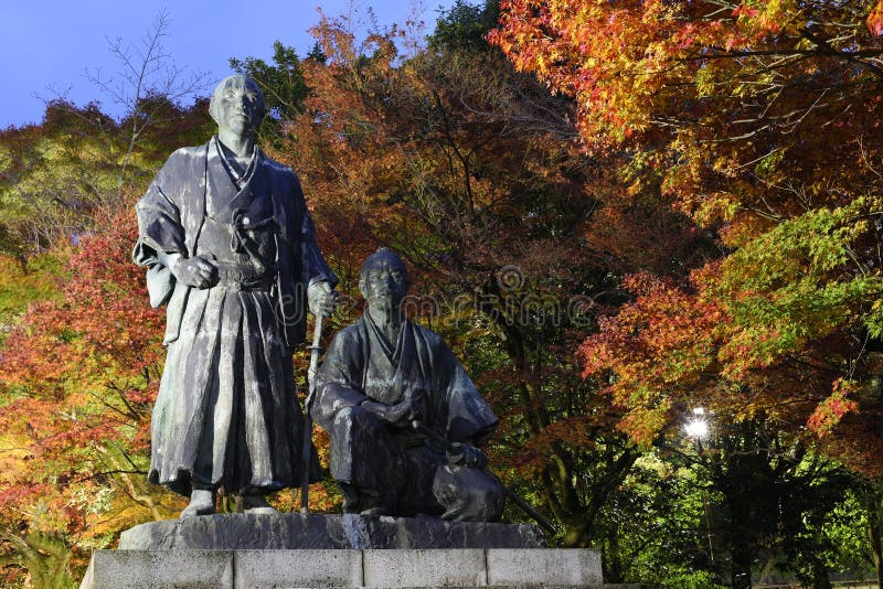 Statue of Sakamoto Ryoma & Nakaoka Shintaro at Maruyama Park with autumn color at dusk, Kyoto, Japan. Statue of Sakamoto Ryoma & Nakaoka Shintaro at Maruyama Park with autumn color at dusk, Kyoto, Japan