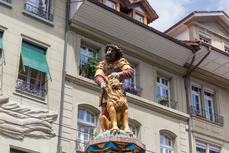 Slaying the lion, 16th century traditional colourful fountains & statues in the old city of Bern, Switzerland. Slaying the lion, 16th century traditional colourful fountains & statues in the old city of Bern, Switzerland
