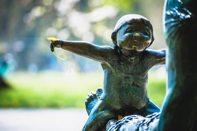 Statue of young child with dandelion