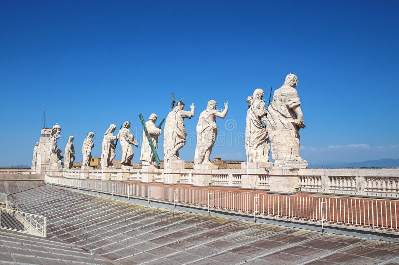 Statues of Jesus Christ, John the Baptist and 11 apostles on the roof of St. Peter`s Cathedral stock photo Statues of Jesus Christ, John the Baptist and 11 apostles on the roof of St. Peter`s Cathedral stock photo