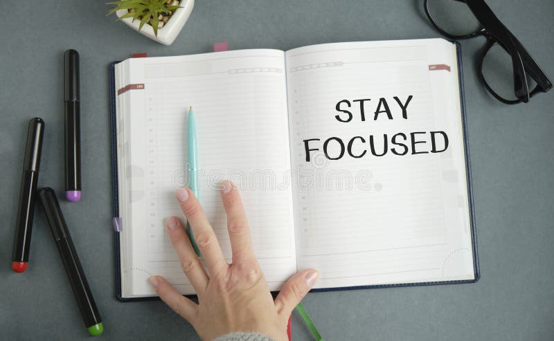 STAY FOCUSED man hand notebook and other stock images