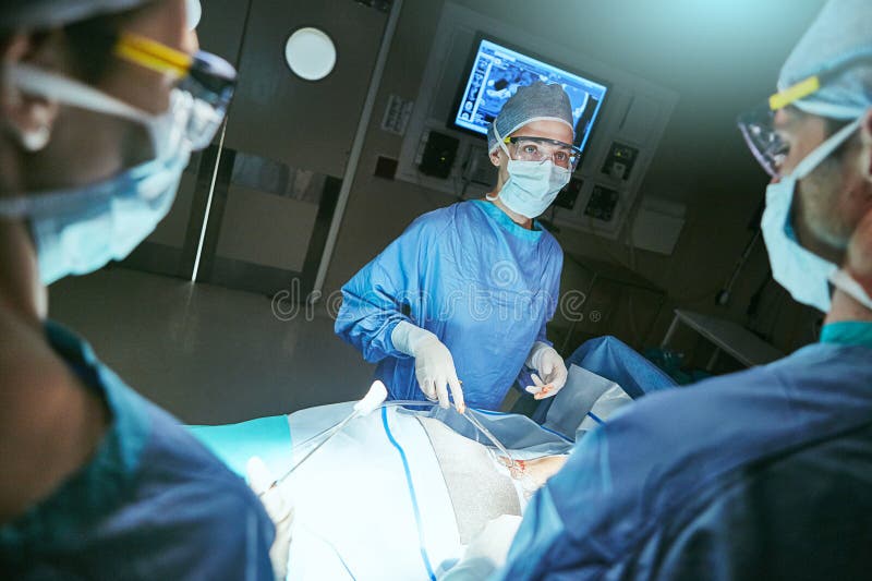 Steady Hands for a Successful Surgery. Surgeons in an Operating Room