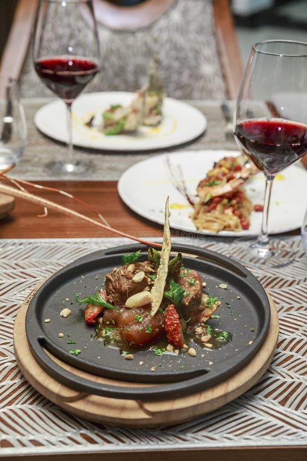 Steak dinner with wine editorial photography. Image of chairs 143469392