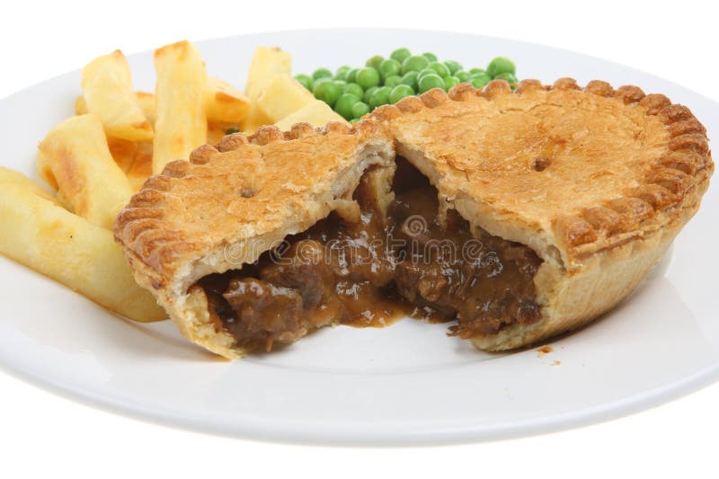 Steak & kidney pie with puff-pastry top, chips and peas. Short DoF. Steak & kidney pie with puff-pastry top, chips and peas. Short DoF.