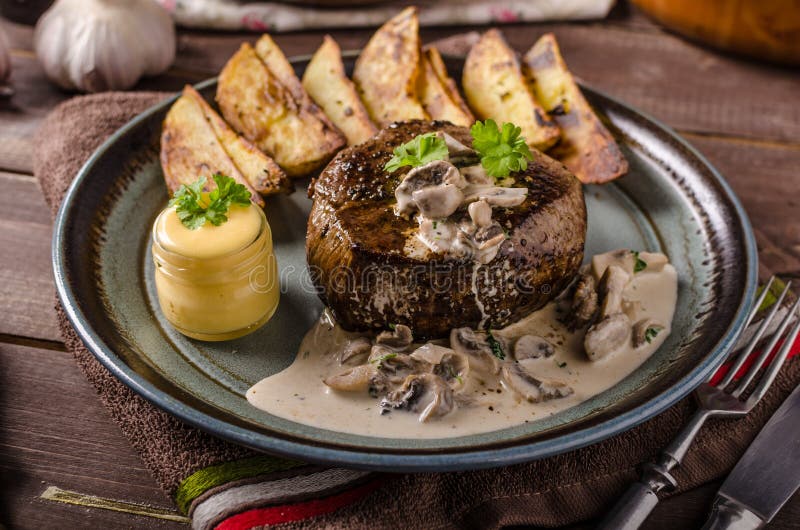 Steak with pepper sauce and mushrooms