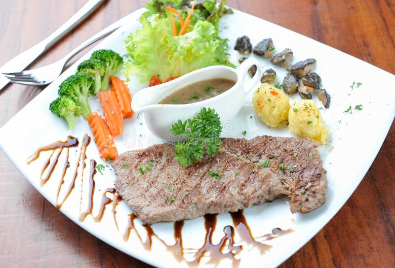 Steak on plate stock photo. Image of porterhouse, cooking 100438648