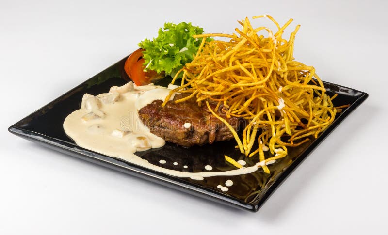 Steak with potato straw in mushroom sauce