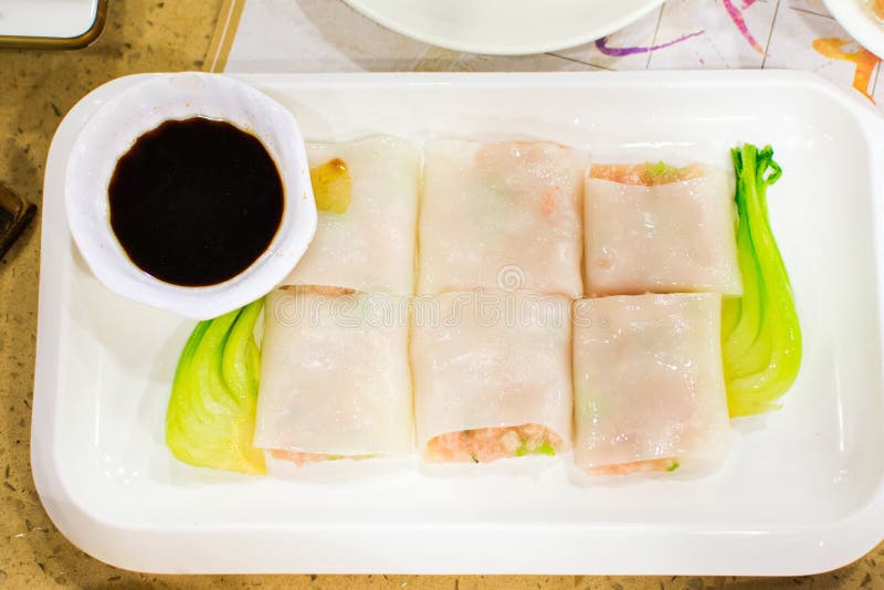 Steam Rice Noodle Roll Stuffed with Pork and Vegetable Served on Stock