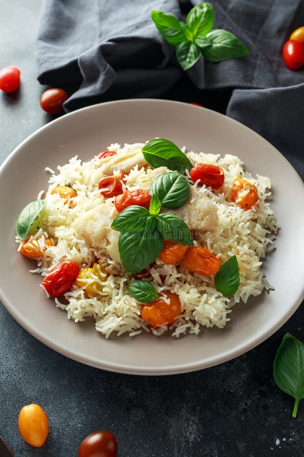 Steamed Cod Fish with Rice and Cherry Mix Tomatoes and Basil Herbs in a ...