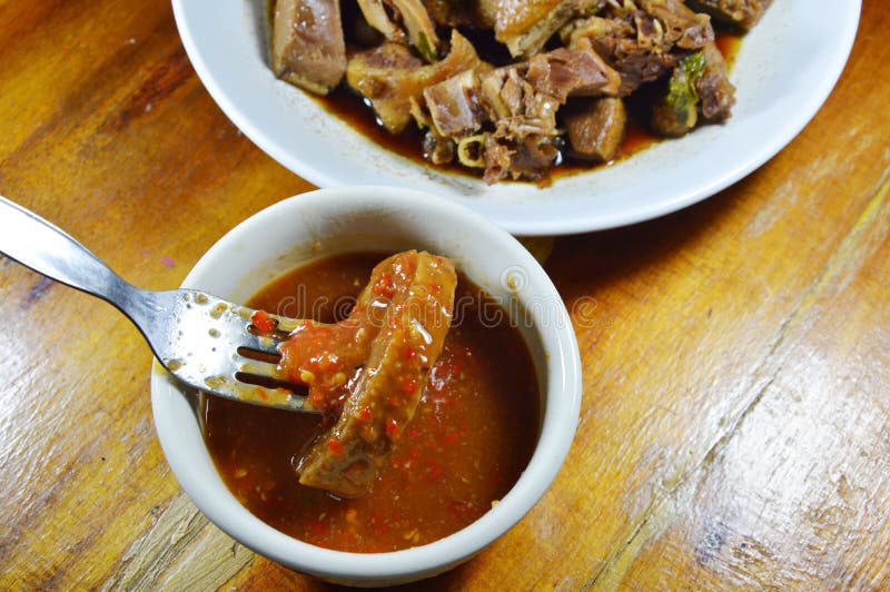 Steamed Duck Meat Stab in Fork Dipping with Spicy and Sour Sauce Stock