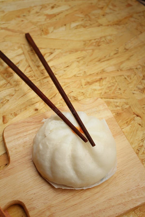 Steamed Dumpling Chinese Bun on Brown Background. Stock Photo Image