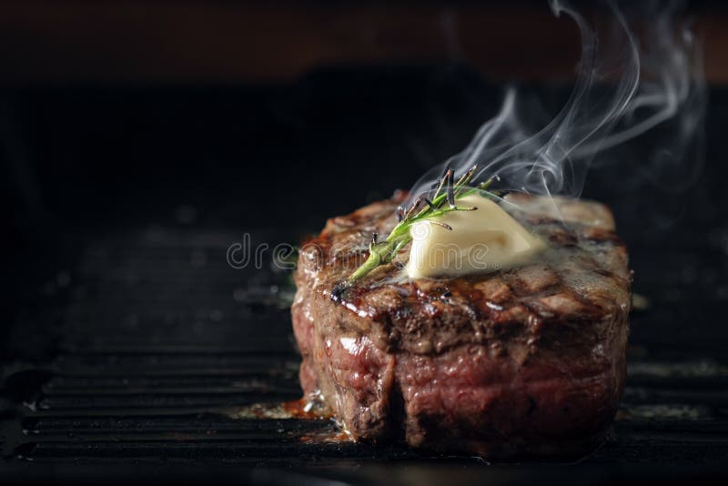 A steaming beef tenderloin steak is grilled