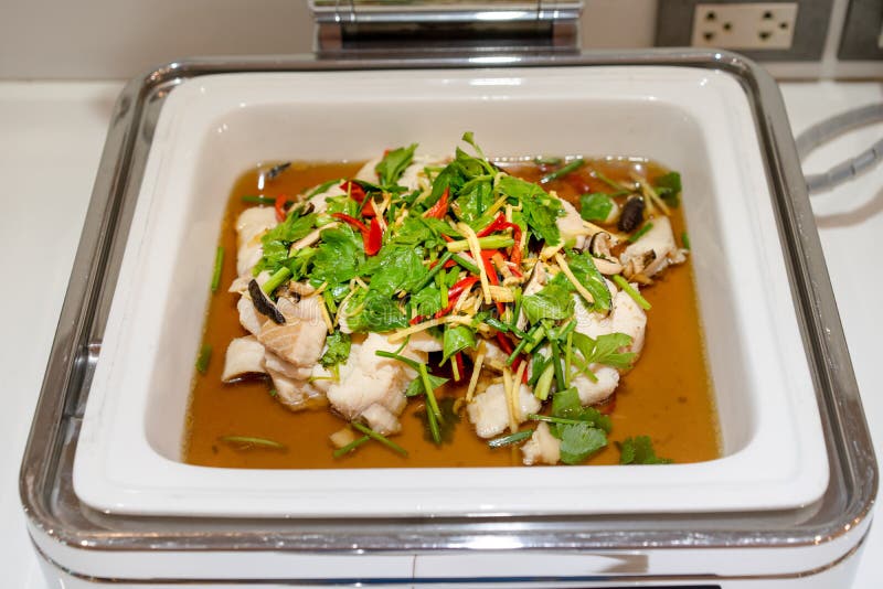 Steaming Fish in Large White Square Bowl at Thailand Resort Stock Photo